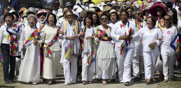 A ativista norte-americana Gloria Steinem (à frente, a quarta da esquerda para a direita) e integrantes do grupo WomanCross marcham com sul-coreanas perto de um ponto de verificação militar na fronteira entre as Coreias  - Lim Byung-Shik/Yonhap/Reuters