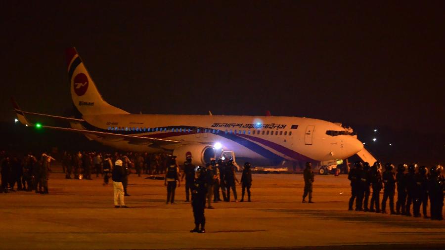 24.fev.2019 - Seguranças são vistos perto de avião da companhia Biman Bangladesh - STR/AFP