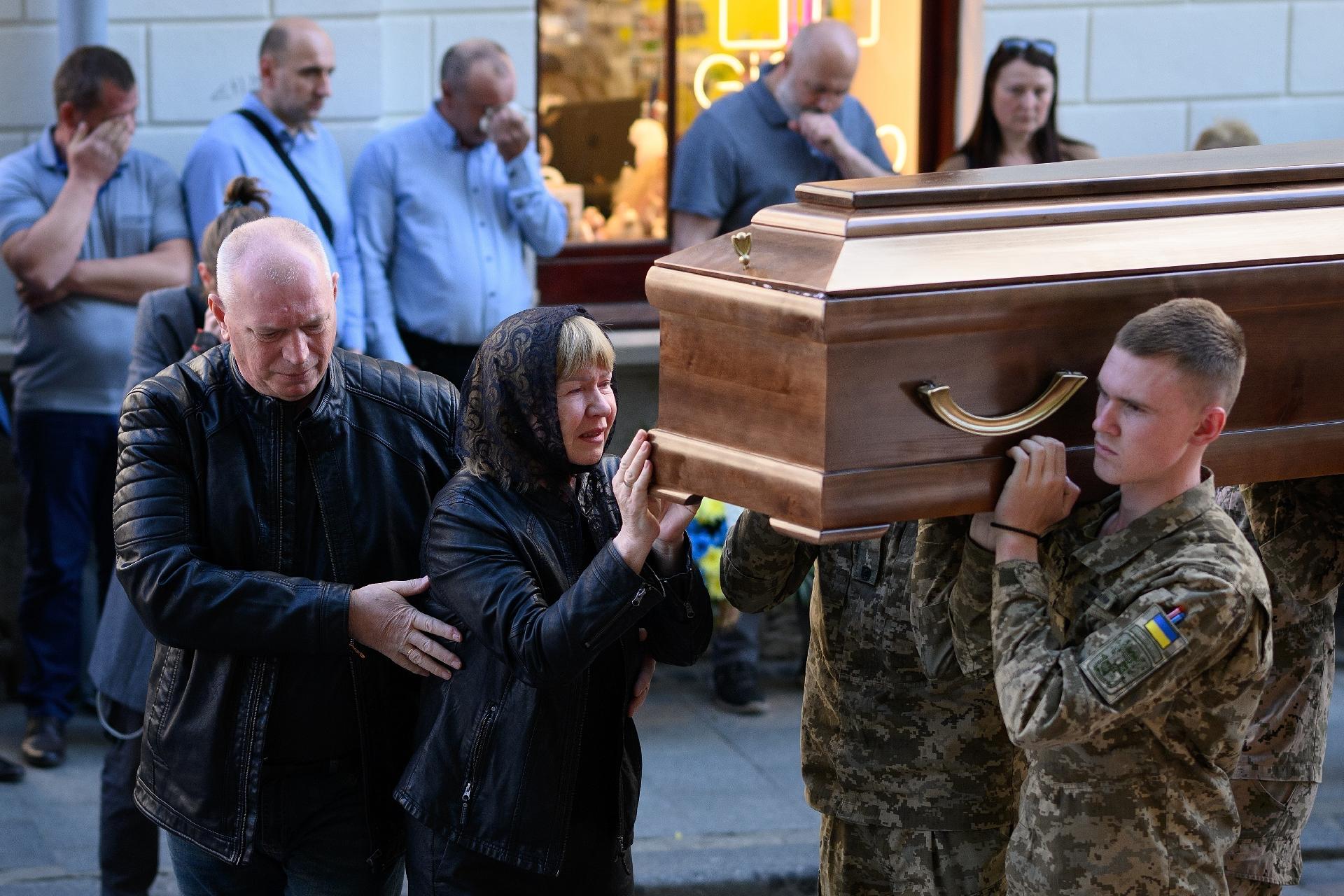 May 10, 2022 - Halyna Moisenko runs to press her face into the coffin before the funeral of her son, Sergeant Olexandr Moisenko, in Lviv, western Ukraine - May 10, 2022 - Leon Neal/Getty Images