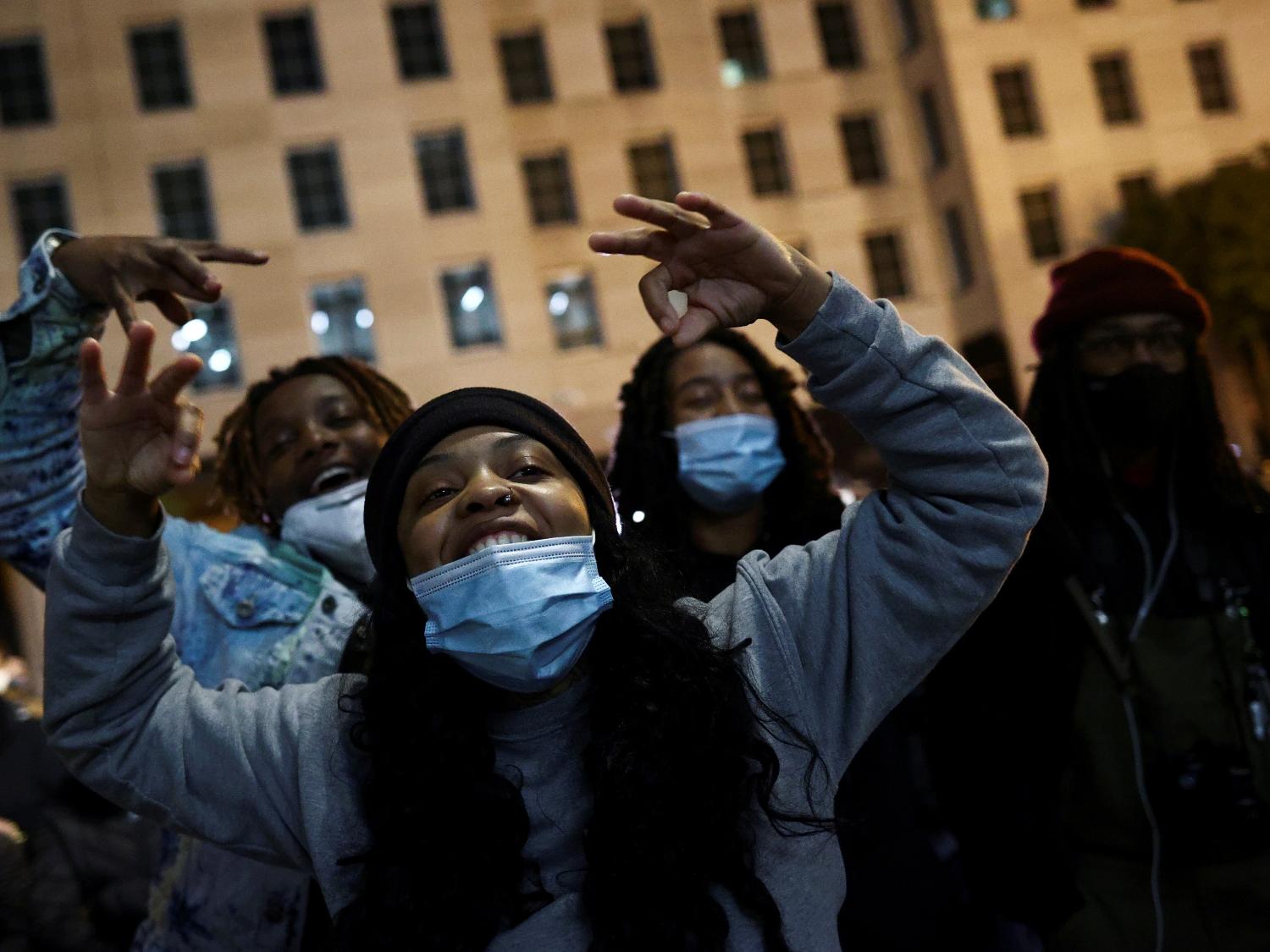 People react as they watch early results on T.V as they gather at Black Lives Matter Plaza near the White House during Election Day in Washington, U.S., November 3, 2020. REUTERS/Hannah McKay - Hannah McKay/Reuters