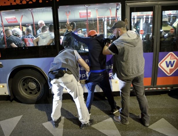 3.jul.2015 - Policiais à paisana revistam homem durante detenção de vários manifestantes em Haia - Marten Van Dijl/ANP/AFP