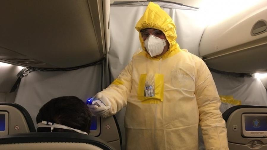 Integrante do corpo médico examina brasileiro que estava em Wuhan, epicentro do coronavírus, durante voo de resgate - Divulgação FAB