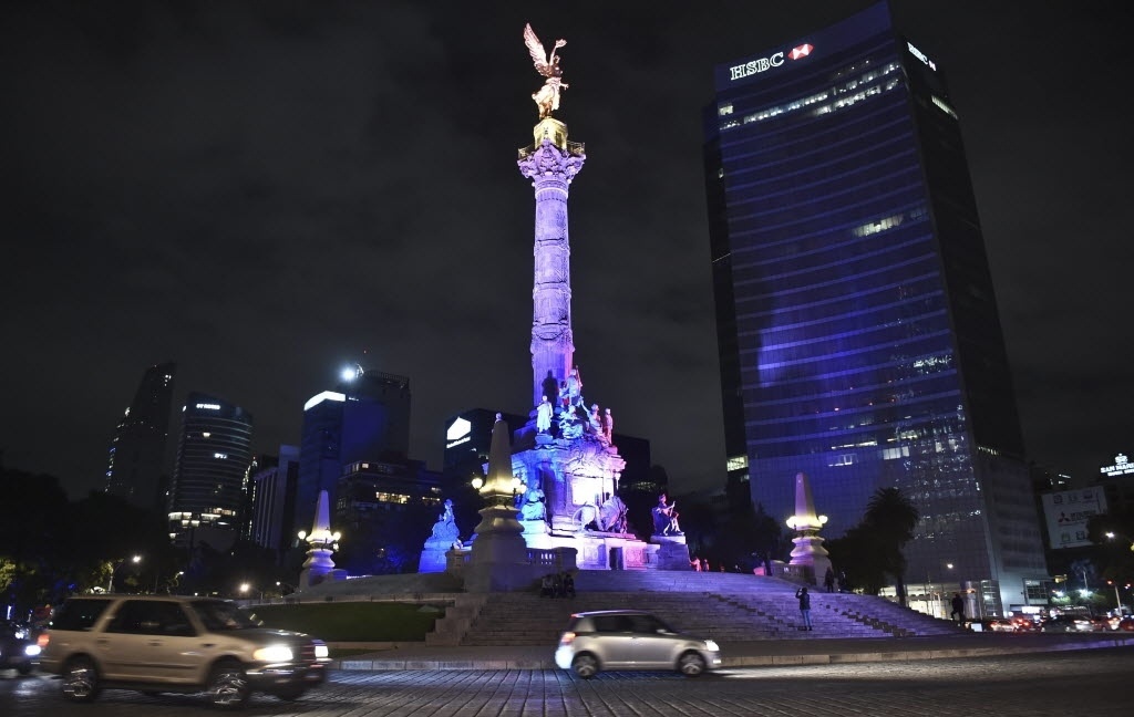 14.nov.2015 - Monumento mexicano pela independência é iluminado com as cores da bandeira nacional francesa, na Cidade do México, capital do país. A homenagem acontece após uma série de ataques terroristas que atingiram Paris na sexta-feira (13) - Yuri Cortez/AFP