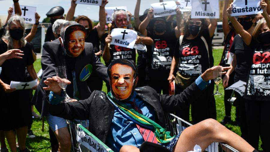 Manifestantes usando máscaras representando o presidente brasileiro Jair Bolsonaro e Arthur Lira, presidente da Câmara dos Deputados do Brasil, participam de um protesto contra o governo de Bolsonaro e Arthur Lira, em frente ao Congresso Nacional em Brasília - MATEUS BONOMI/ESTADÃO CONTEÚDO