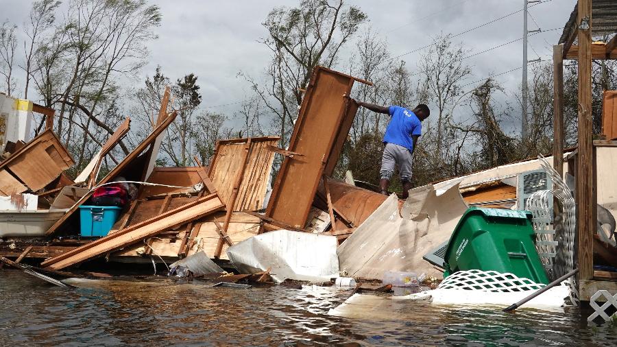 30.ago.21 - Homem resgata itens da casa de sua mãe após local ser destruído pelo furacão Ida em Laplace, Louisiana - SCOTT OLSON/Getty Images via AFP