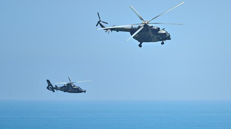 Military helicopters pass near Pingtan island in Fujian, China's closest point to Taiwan - HECTOR RETAMAL/AFP - HECTOR RETAMAL/AFP