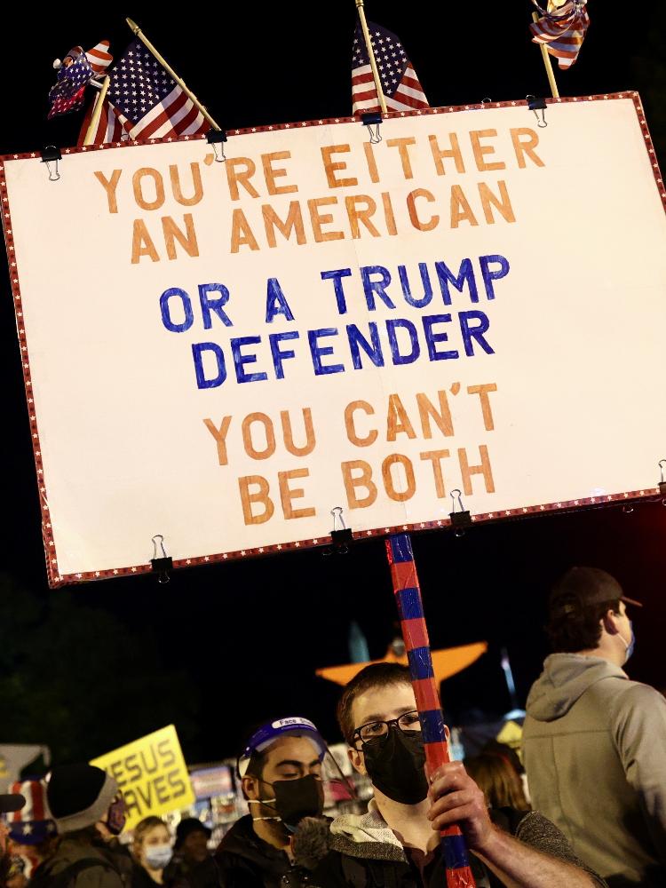 Supporters of U.S. Democratic presidential nominee Joe Biden gather at the "Black Lives Matter Plaza" near the White House during Election Day in Washington, U.S., November 3, 2020. REUTERS/Hannah McKay ORG XMIT: MEX - Hannah McKay/Reuters