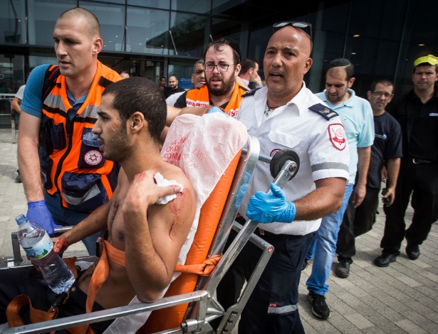 Uri Rezken é socorrido após ser esfaqueado em Kiryat Ata, no subúrbio de Haifa (Israel) - Xinhua/JINI