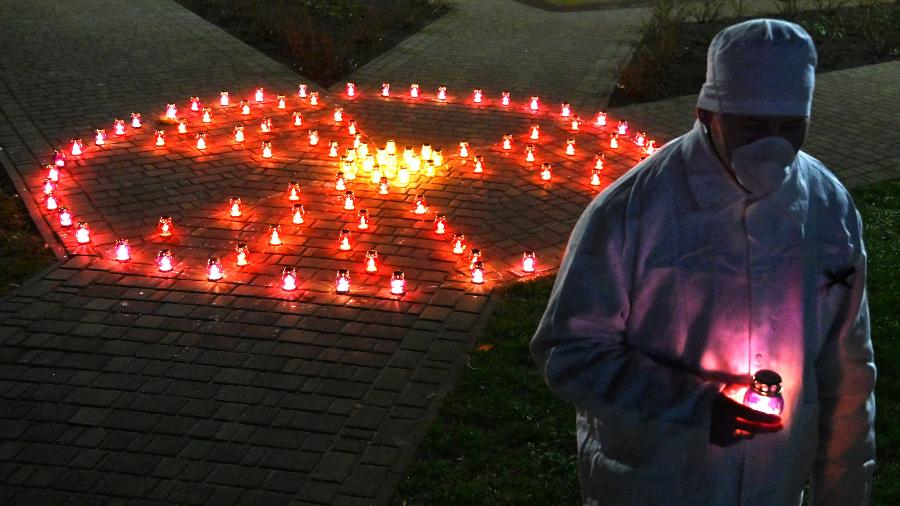 25.abr.2021 - Homem segura vela em homenagem às vítimas de Chernobyl em Slavutych, cidade onde trabalhadores da usina moravam - Sergei Supinsky/AFP