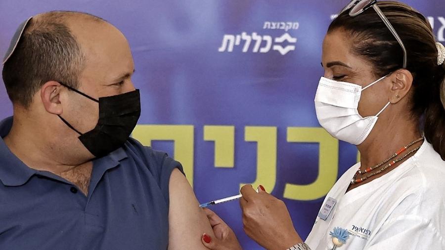 20.ago.2021 - O primeiro-ministro de Israel, Naftali Bennett, recebe a terceira dose da vacina contra a covid-19 - jack Guez/AFP