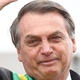 O presidente Jair Bolsonaro e o garoto Ivo Cesar Gonzalez, que estava entre o público na esplanada e foi chamado pelo presidente para subir no carro durante o desfile do 7 de Setembro - Pedro Ladeira/Folhapress