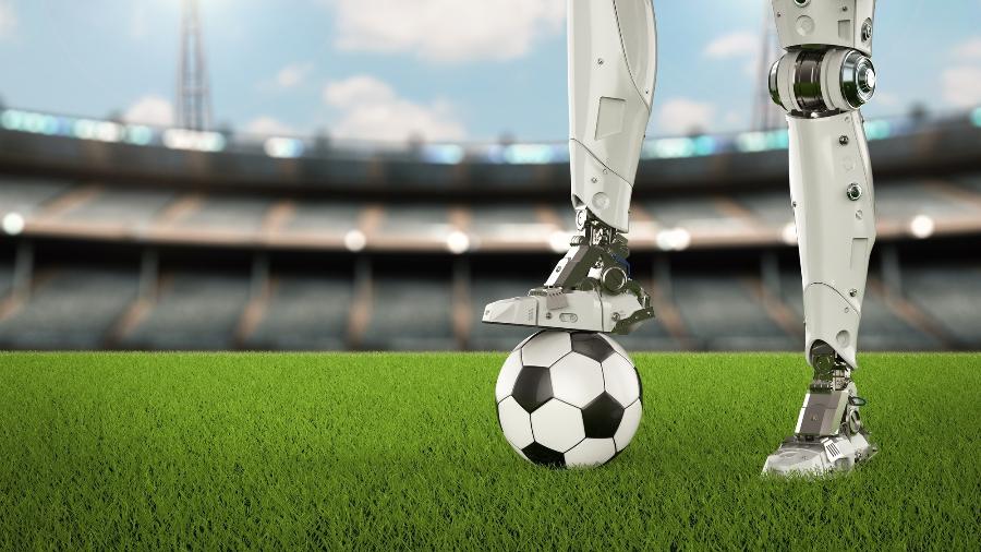 Ilustração de robô com pé sobre bola de futebol - Getty Images