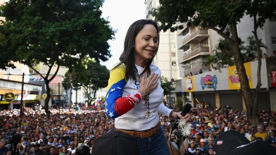 A líder da oposição venezuelana, Maria Corina Machado, gesticula ao fazer um discurso durante um protesto convocado pela oposição na véspera da posse presidencial, em Caracas - FEDERICO PARRA/AFP