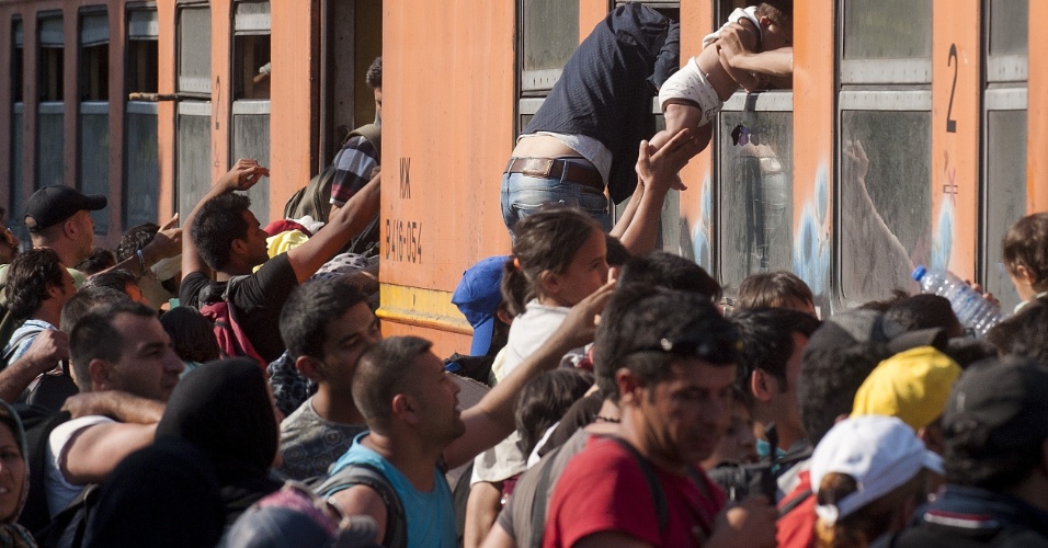 21.jul.2015 - Refugiados sírios e de outras partes do Oriente Médio tentam embarcar em trem na fronteira entre Grécia e Macedônia. O objetivo é chegar à Hungria e, de lá, rumar para países como Alemanha, Dinamarca, Bélgica, França e Reino Unido. Autoridades húngaras querem acelerar a instalação de cercas ao longo da fronteira com a Sérvia para conter o fluxo de refugiados