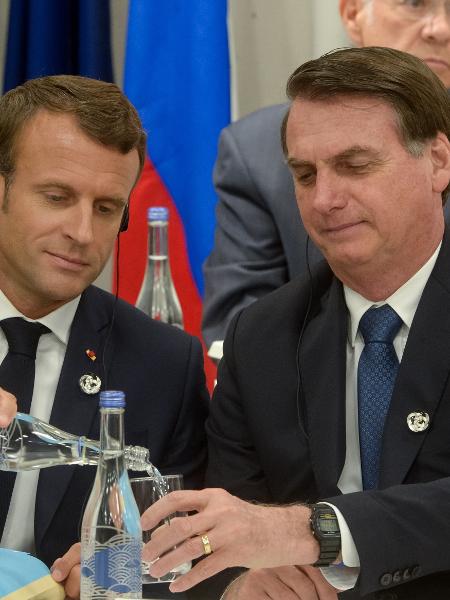 28.jun.2019 - Presidente do Brasil, Jair Bolsonaro, e o presidente da França, Emmanuel Macron, durante reunião dos líderes do G20, em Osaka (Japão) - Frederico Mellado / ARG