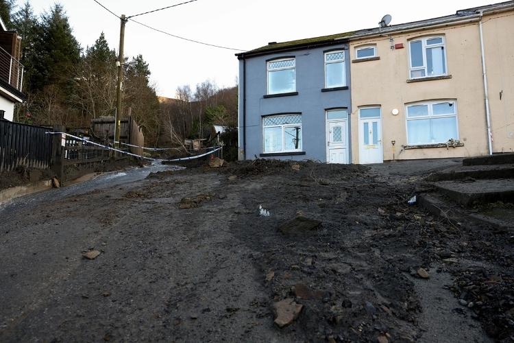 A imagem mostra uma estrada coberta de lama e uma área isolada próxima a casas no local de um deslizamento de terra, após a tempestade Bert, em Cwmtillery, Gales do Sul, Grã-Bretanha, 25 de novembro de 2024.