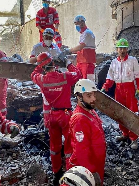 17.jun.2025 - Membros das equipes de resgate do Crescente Vermelho Iraniano vasculham os escombros dentro de um prédio em Teerã, alvo de ataques israelenses 17.jun.2025 - Membros das equipes de resgate do Crescente Vermelho Iraniano vasculham os escombros dentro de um prédio em Teerã, alvo de ataques israelenses