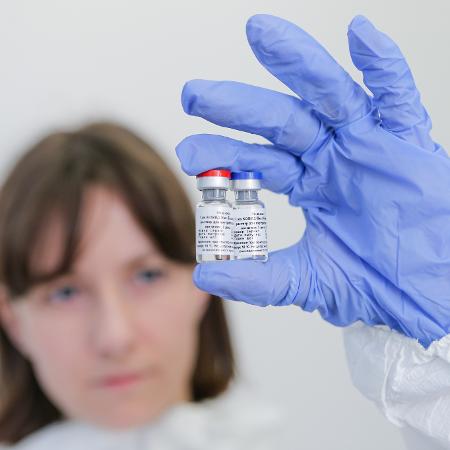 Pesquisadora exibe vacina contra o coronavírus registrada pela Rússia - RDIF/Handout via Xinhua