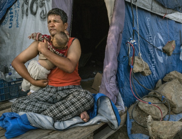 Rulam Heidari, de Mazar-i-Sharif, no Afeganistão, com sua filha de oito meses, Firish, em sua tenda improvisada nos arredores de Moria, em Lesbos, na Grécia - Mauricio Lima/The New York Times