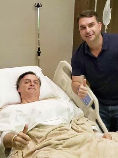 O presidente Jair Bolsonaro ao lado do filho, o senador Flávio Bolsonaro (PSL-RJ), após cirurgia em São Paulo neste domingo (8) - Reprodução/Twitter