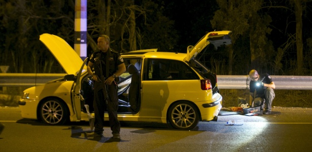 Policiais vistoriam carro usado por árabe-israelense para atacar quatro israelenses em Gan Shmuel, próximo a Hadera (Israel)