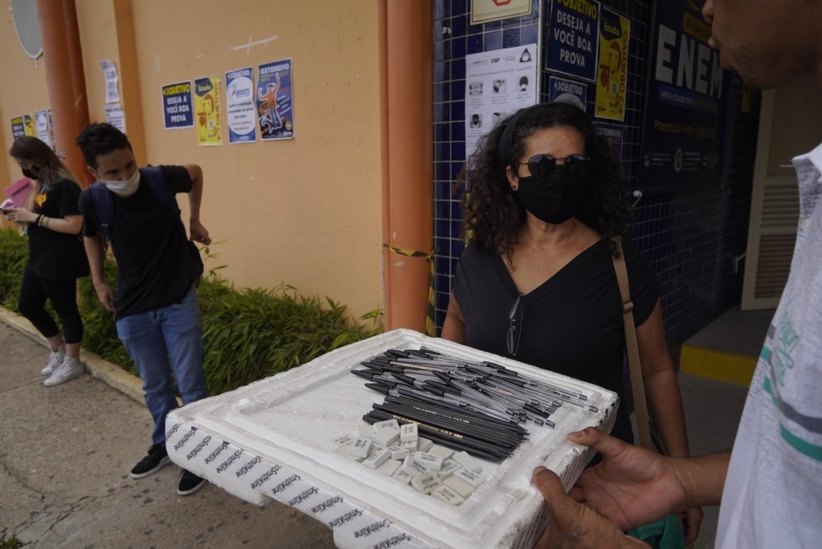 Ambulante vende caneta preta, lápis e borrachas na porta de universidade em São Paulo no 1º dia de prova do Enem impresso - André Porto/UOL