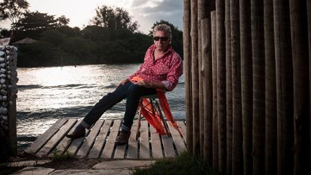 No deck de sua casa, à beira da Lagoa da Tijuca; camisa de estrelas, echarpe laranja e meia furada - Lucas Seixas - Lucas Seixas