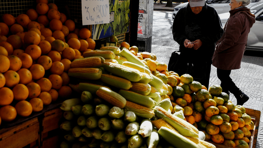 Consumidor conta dinheiro antes de comprar frutas em Buenos Aires 