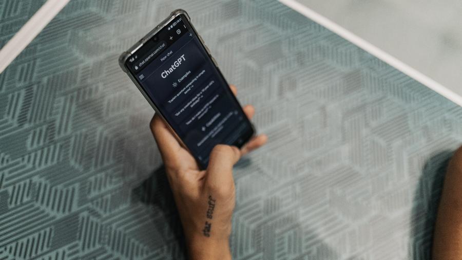 Mão feminina segura um celular com aplicativo do ChatGPT Mão feminina segura um celular com aplicativo do ChatGPT