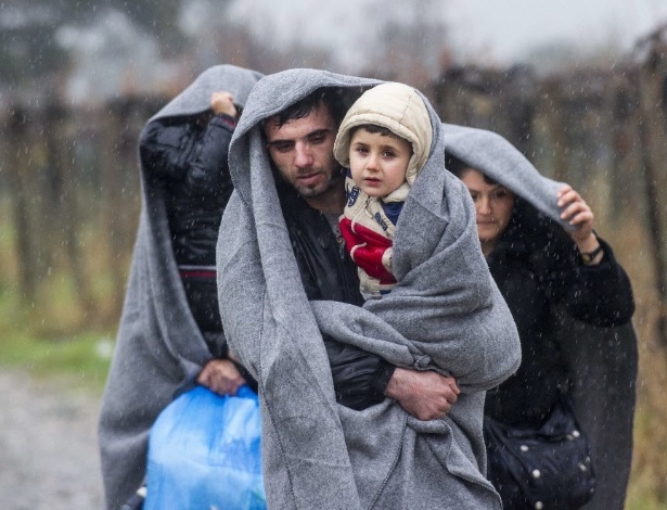 Refugiados enfrentam chuva na passagem pela fronteira entre Grécia e Macedônia - Robert Atanasovski/AFP