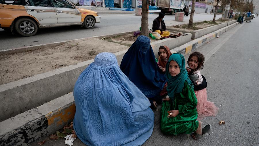 26.out.21 - Mulheres usando burcas sentam-se com seus filhos ao longo de uma estrada em Cabul, Afeganistão - ZOHRA BENSEMRA/REUTERS