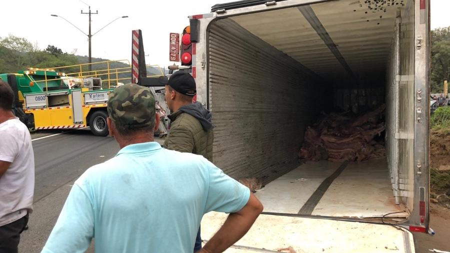 População retira carne de um caminhão tombado na Rodovia Régis Bittencourt, em São Paulo - Lucas Borges Teixeira/UOL