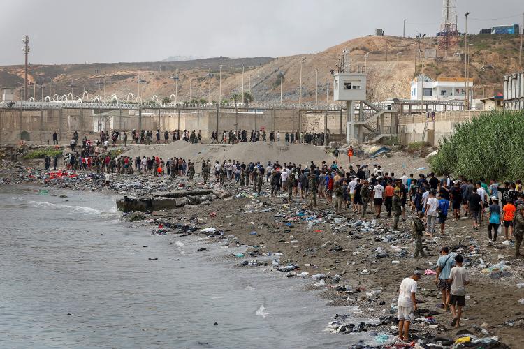 31.jul.2026 - Pessoas caminham em direção à fronteira com o Marrocos, deixando a Espanha, em meio a travessias em massa do Marrocos para Ceuta