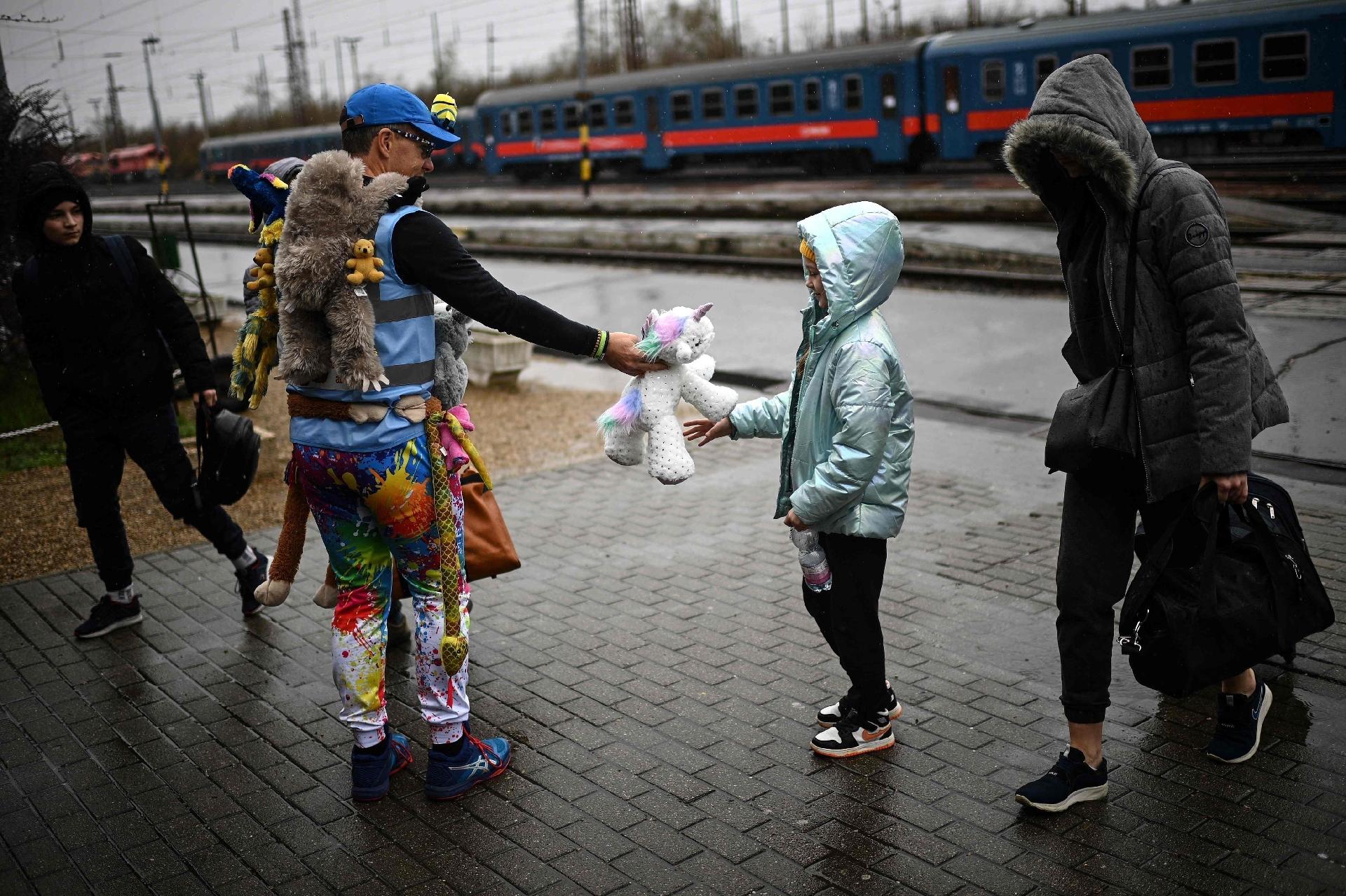 Apr 9, 2022 - A Ukrainian refugee girl receives a plush toy when she arrives at the Zahony train station on the Ukraine-Russia border - Apr 9, 2022 - Christophe Archambault/AFP