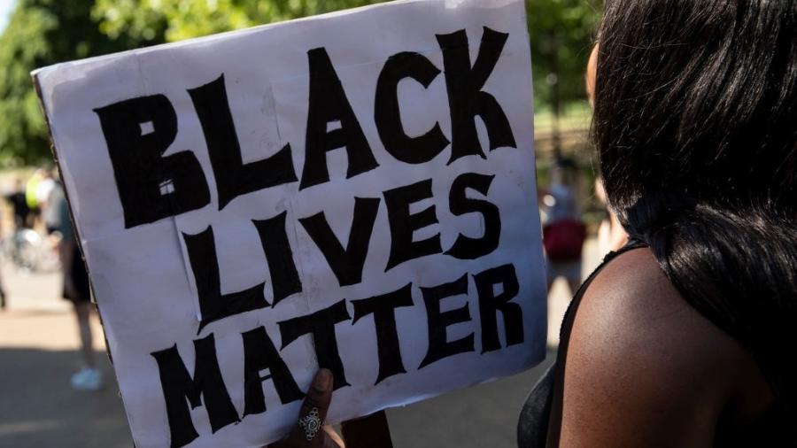 "Vidas negras importam", diz o cartaz que a mulher segura em protesto realizado em Londres, nesta segunda-feira, após a morte do afro-americano George Floyd, nos Estados Unidos - Dan Kitwood/Getty Images