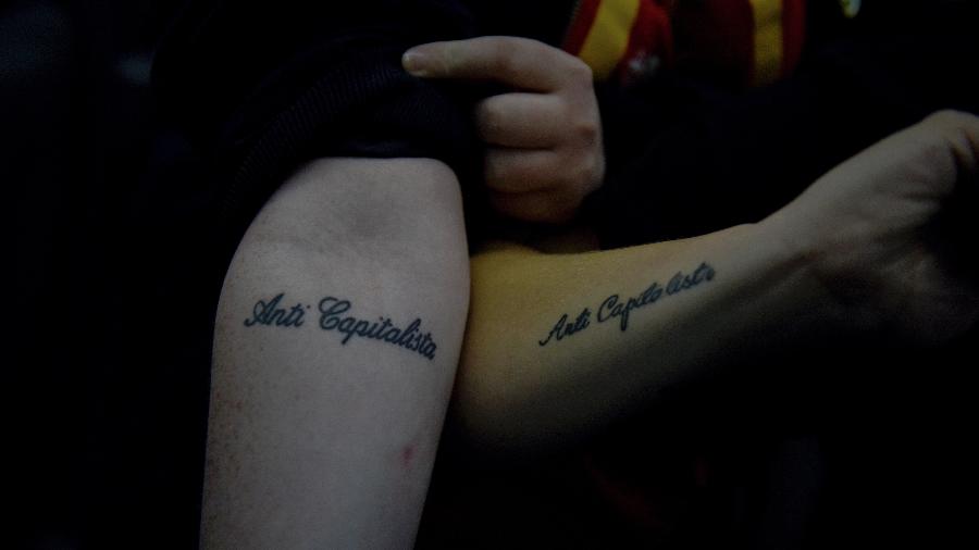 Lauren McCourt e Shen Batman mostram suas tatuagens iguais em Brighton, na Inglaterra - Mary Turner/The New York Times