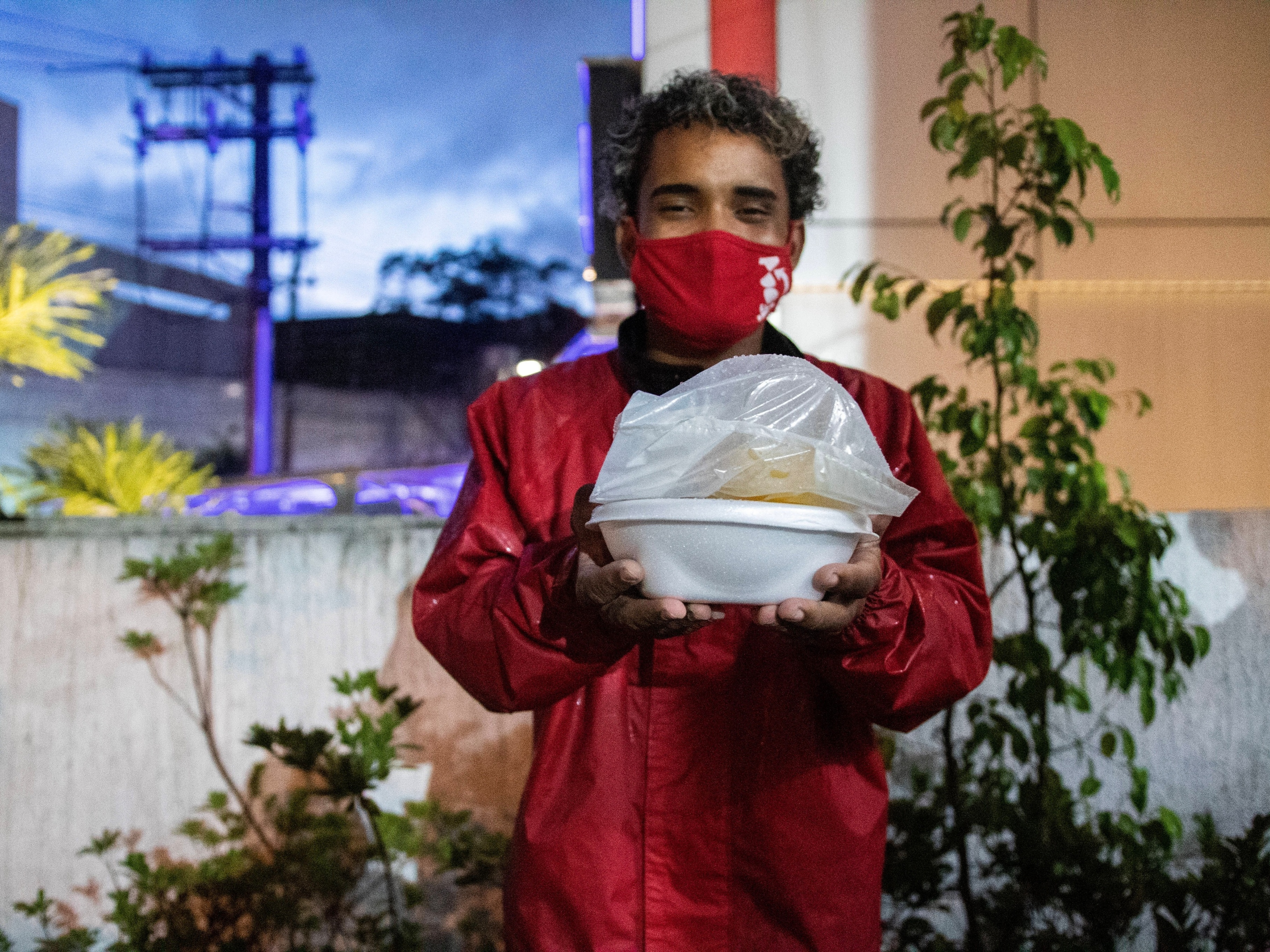 Entregadores de comida fazem fila para receber marmitas doadas em SP