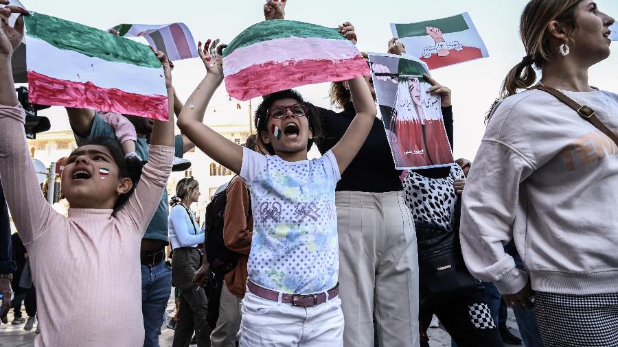 08.out.22 - Iranianos que vivem na Grécia cantam slogans e seguram cartazes nas cores da bandeira iraniana durante uma manifestação em Thessaloniki - SAKIS MITROLIDIS/AFP