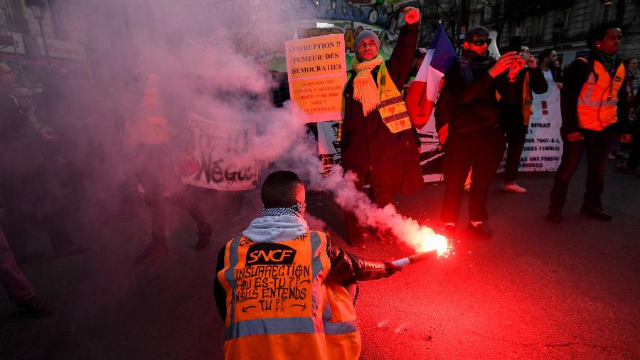 19.dez.2019 - Manifestantes acendem sinalizadores durante protesto entre a Gare de Lyon e a Gare de l"Est, em Paris, no 15º dia de greve em vários setores, incluindo o de transportes públicos, contra as mudanças na Previdência propostas pelo governo - Lionel Bonaventure/AFP