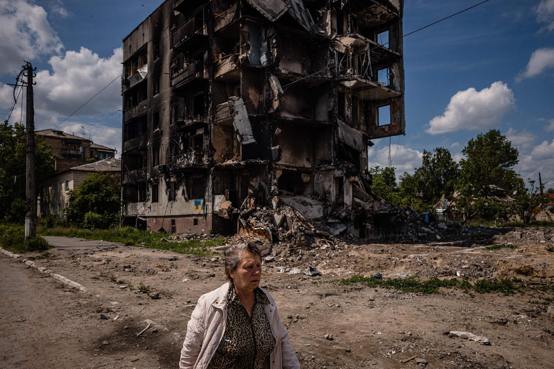 June 1, 2022 - A woman walks by a destroyed apartment building in the city of Borodyanka, Kyiv region - June 1, 2022 - Dimitar Dilkoff/AFP