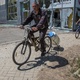 A man on a bicycle carries water in Lysychansk, Ukraine, as Russian attacks continue - Oleksandr Ratushniak/Reuters