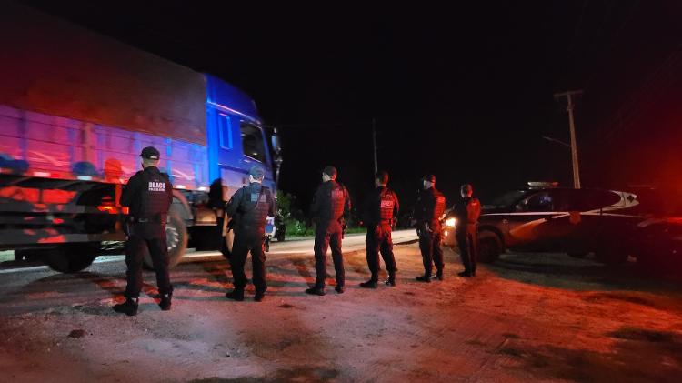 Policiais abordam caminhão em barreira durante buscas de fugitivos