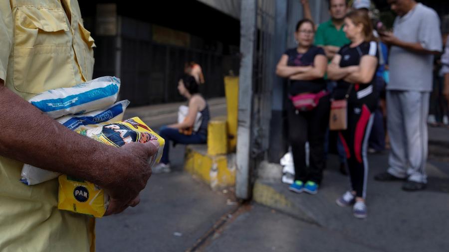 27.mar.2019 - Pessoas fazem fila em uma supermercado para comprar farinha e açúcar durante o apagão em Caracas - Carlos Garcia Rawlins/Reuters