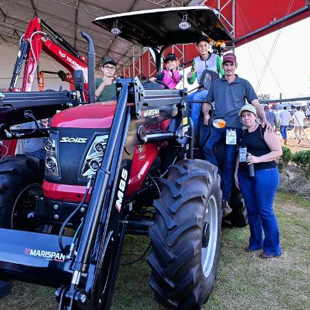 Família em estande de máquinas agrícolas na Agrishow Família em estande de máquinas agrícolas na Agrishow