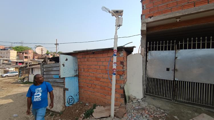 José Benedito, morador da ocupação Anchieta, na zona sul de São Paulo, observando poste movido à energia solar