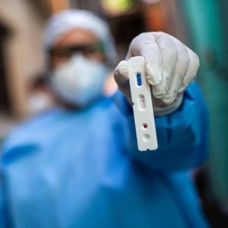3.set.2020 - Agente de saúde segura teste com resultado positivo para o novo coronavírus durante testagem na favela da Mangueira, no Rio de Janeiro - Bruna Prado/Getty Images