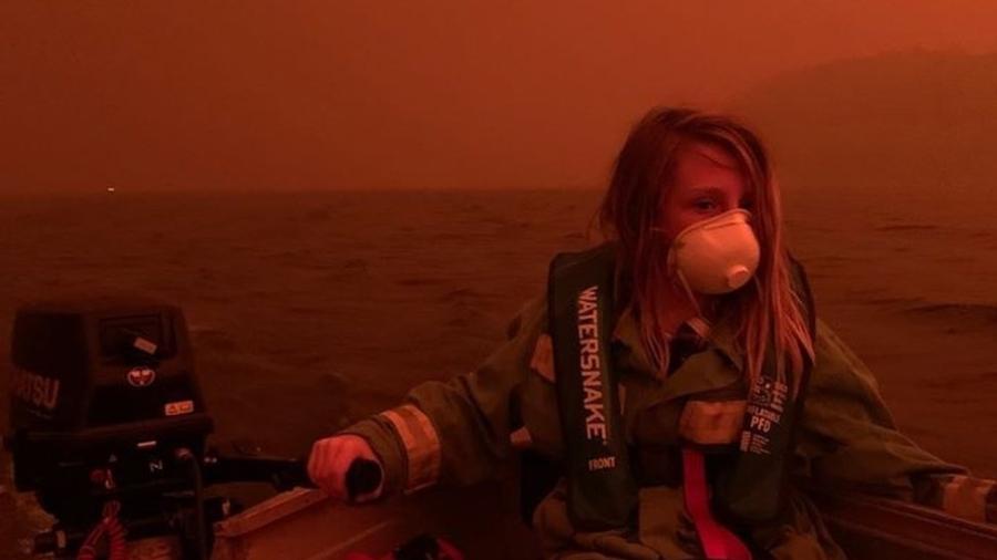 Criança usa máscara e colete salva-vidas enquanto família fugia de barco para escapar de incêndio em Mallacoota - ABC News