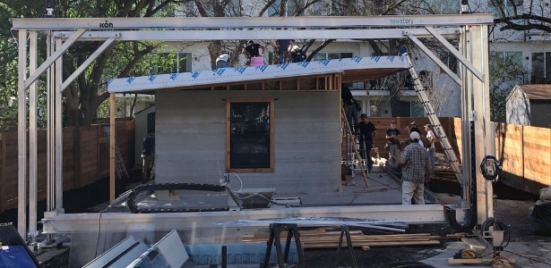 Casa impressa em 3D - O quadro de impressão, em primeiro plano, passa por área de construção com trilhos - BBC - BBC