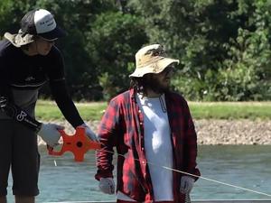 Researchers in a river - Equitas - Equitas