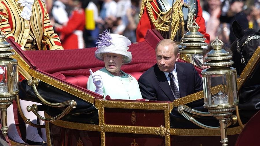 2003 - Como parte da primeira visita de estado por um líder russo desde 1874, o presidente Putin da Federação Russa anda com a rainha Elizabeth 2ª em uma carruagem aberta em uma procissão, em foto de  - Tim Graham Photo Library via Getty Images